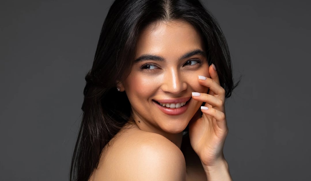 A Person With A Natural Smile And Balanced Facial Features, Representing The Subtle, Refined Aesthetic Of A Natural-Looking Nose Job.